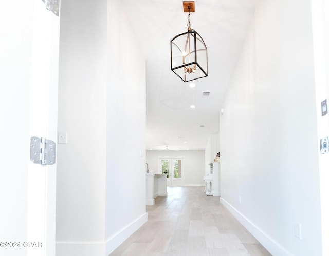 hall featuring a chandelier, recessed lighting, visible vents, and baseboards