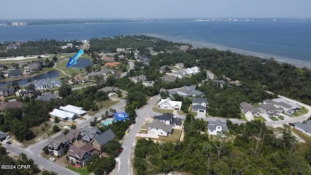 birds eye view of property with a water view and a residential view