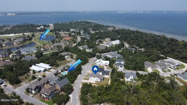 drone / aerial view featuring a water view and a residential view