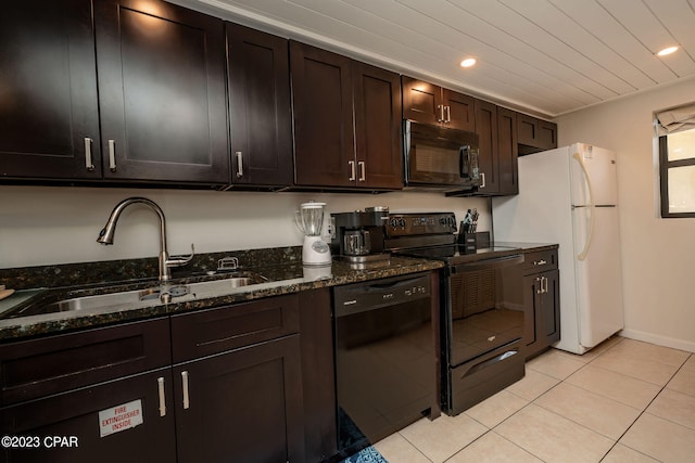 kitchen with sink, dark stone countertops, dark brown cabinets, light tile patterned floors, and black appliances