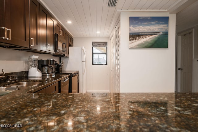 kitchen featuring sink, dark brown cabinetry, black electric range oven, and dark stone countertops