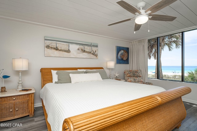 bedroom with ceiling fan, a water view, wooden ceiling, and dark hardwood / wood-style floors