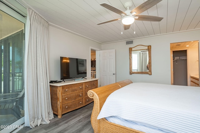 bedroom with dark hardwood / wood-style flooring, a closet, ceiling fan, and ornamental molding