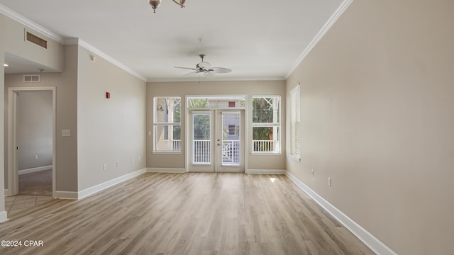 spare room featuring ceiling fan, light wood-type flooring, crown molding, and french doors