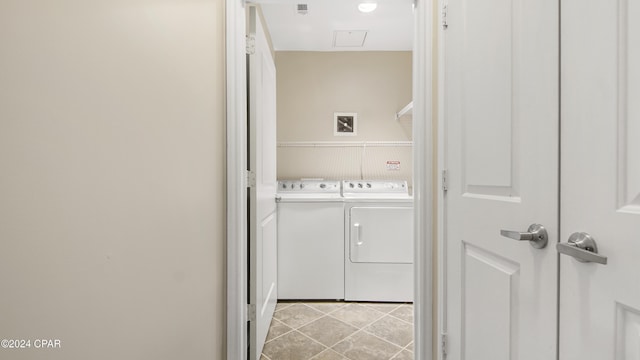 laundry room with light tile patterned floors and washing machine and clothes dryer