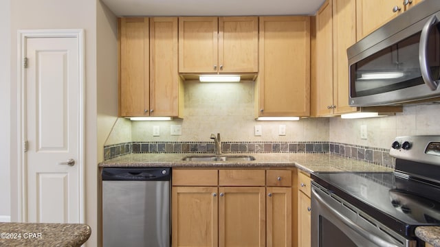 kitchen featuring decorative backsplash, sink, and stainless steel appliances