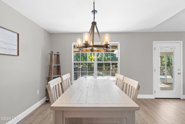 dining room with an inviting chandelier and light wood-type flooring