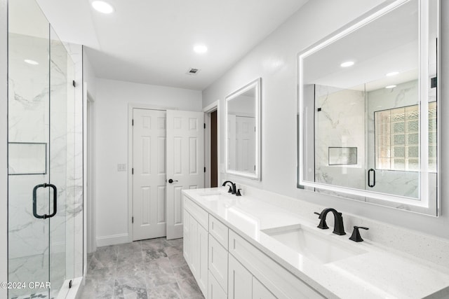 bathroom with vanity and a shower with door