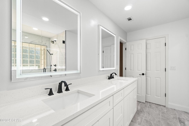 bathroom featuring vanity and tiled shower