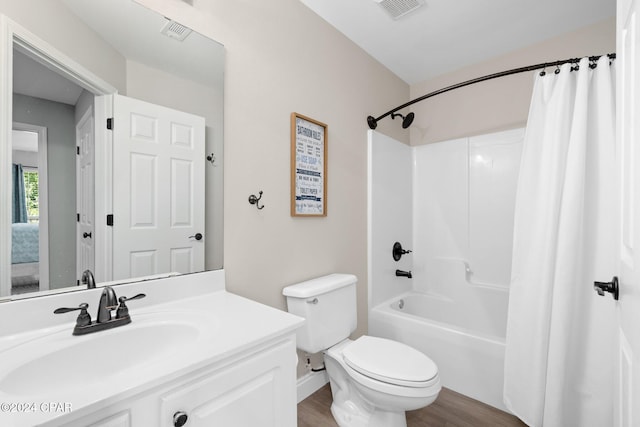 full bathroom featuring vanity, toilet, hardwood / wood-style flooring, and shower / bathtub combination with curtain