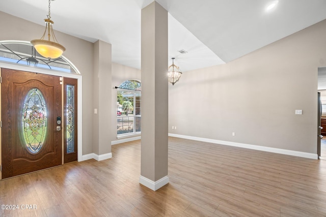 entrance foyer with light hardwood / wood-style floors and an inviting chandelier