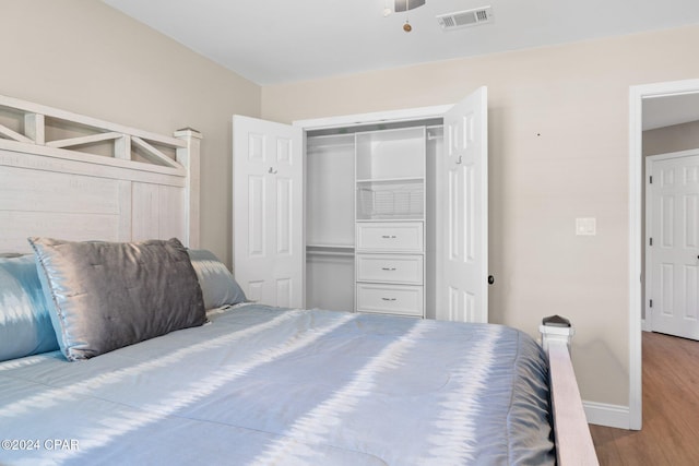 bedroom with hardwood / wood-style floors and a closet