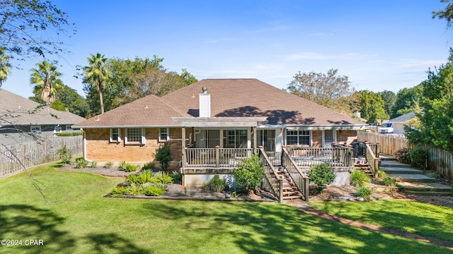 rear view of property with a yard