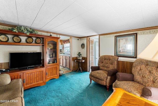 carpeted living room featuring crown molding and wooden walls