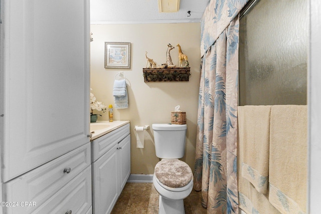 bathroom with tile patterned flooring, vanity, and toilet