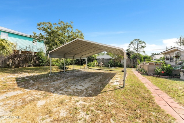 view of parking featuring a carport and a yard