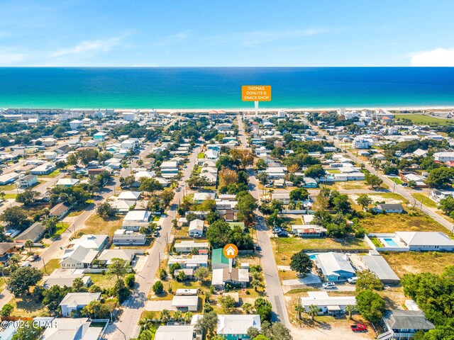 drone / aerial view with a water view and a beach view