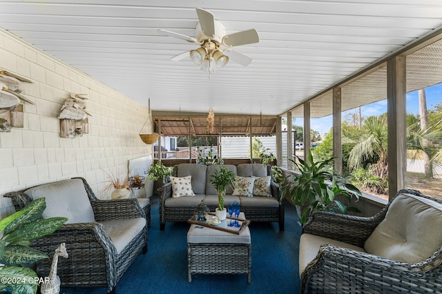 sunroom / solarium featuring ceiling fan