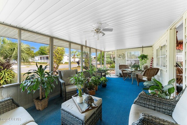 sunroom / solarium featuring ceiling fan