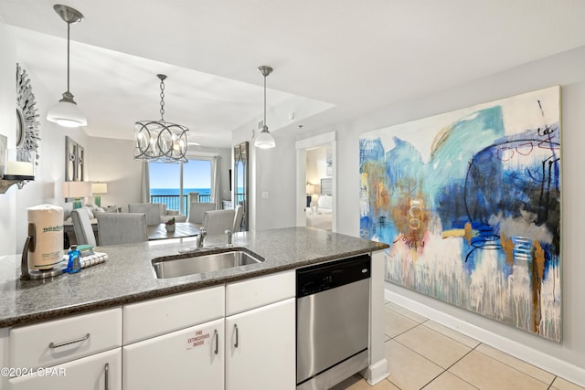 kitchen featuring pendant lighting, white cabinetry, a water view, and dishwasher