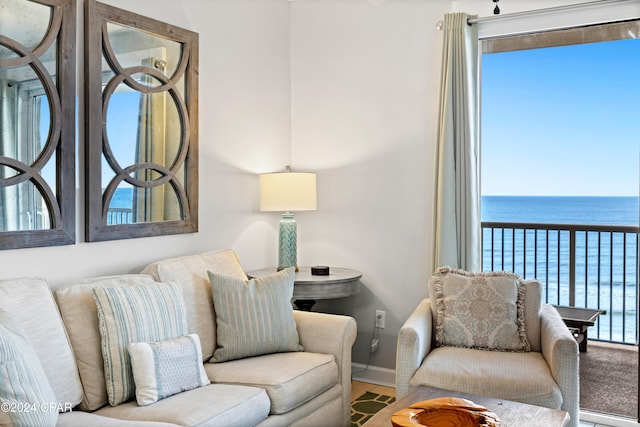 living room with hardwood / wood-style floors, a wealth of natural light, and a water view