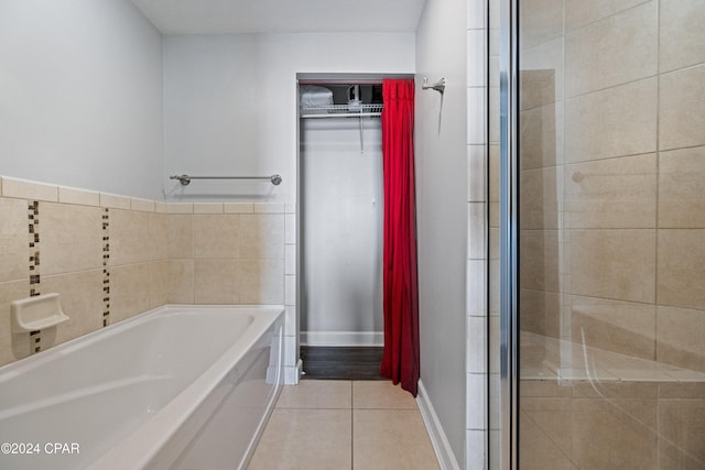 bathroom featuring independent shower and bath and tile patterned flooring