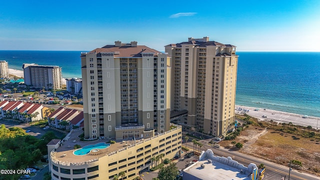 birds eye view of property featuring a water view and a beach view