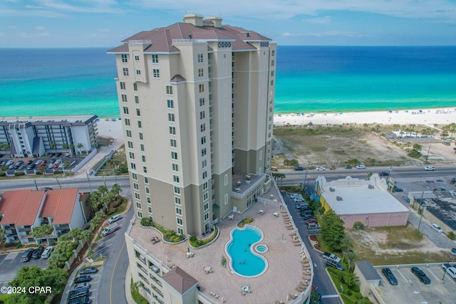 drone / aerial view with a water view and a beach view