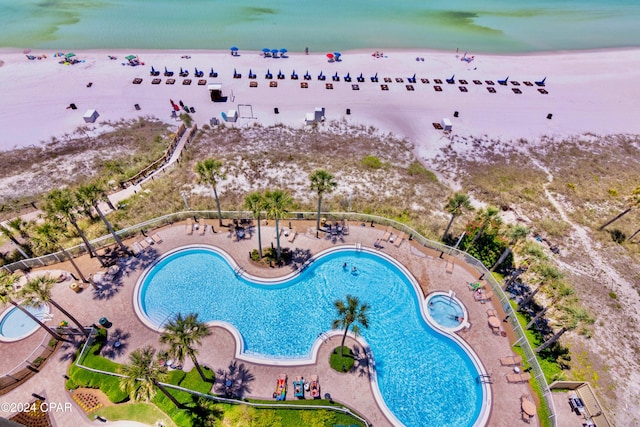 birds eye view of property with a beach view and a water view