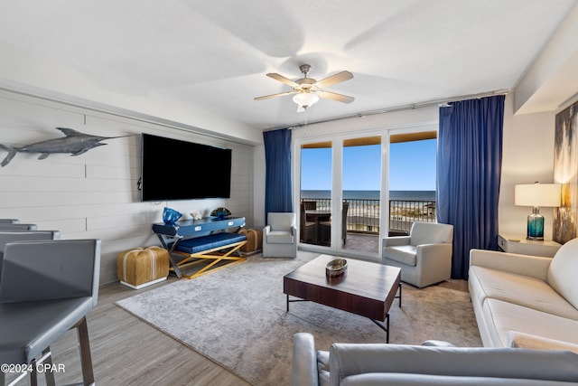 living room with light wood-type flooring and ceiling fan