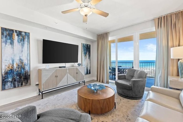 living room featuring hardwood / wood-style flooring and ceiling fan