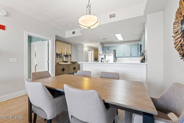 dining space with light wood-type flooring