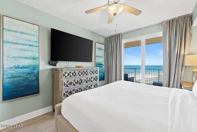 bedroom featuring hardwood / wood-style flooring, ceiling fan, and access to outside