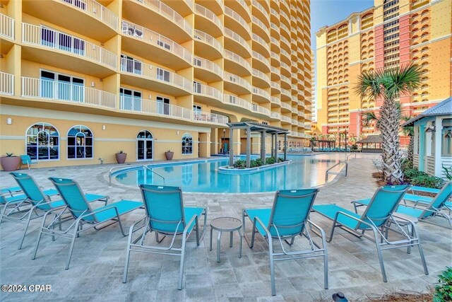view of swimming pool featuring a pergola and a patio