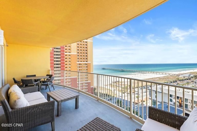 balcony with a water view and a beach view