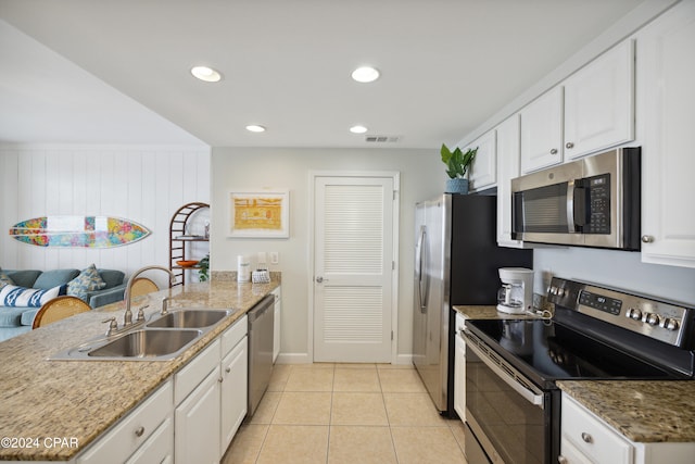 kitchen with white cabinets, appliances with stainless steel finishes, and sink