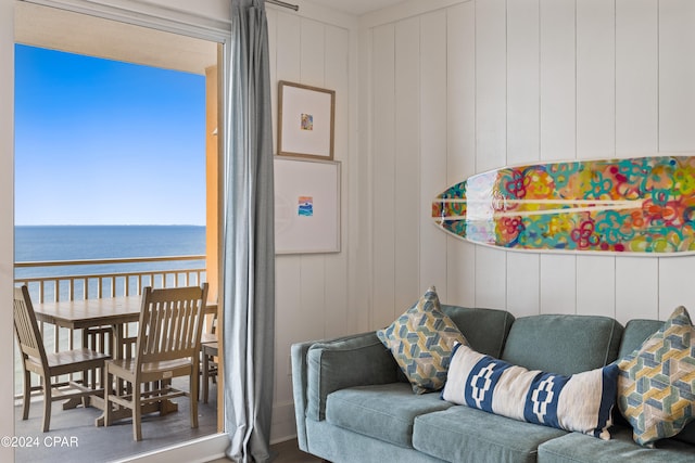 living room featuring wood walls and a water view