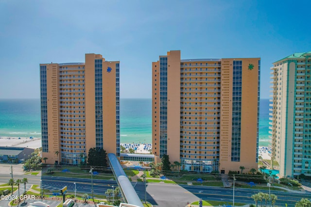 view of building exterior with a view of the beach and a water view