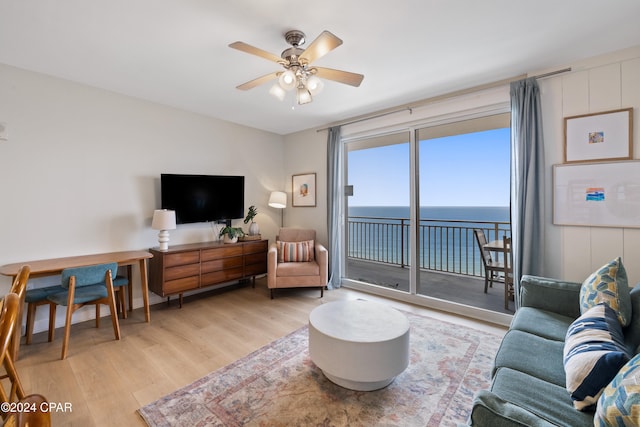 living room featuring ceiling fan and light hardwood / wood-style floors