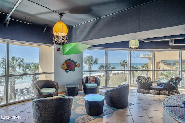 sunroom featuring a water view