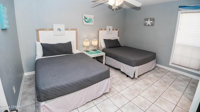 bedroom with tile patterned flooring and ceiling fan