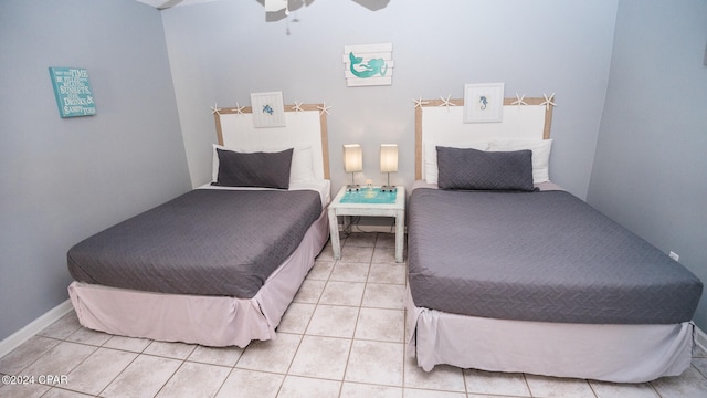 tiled bedroom featuring ceiling fan