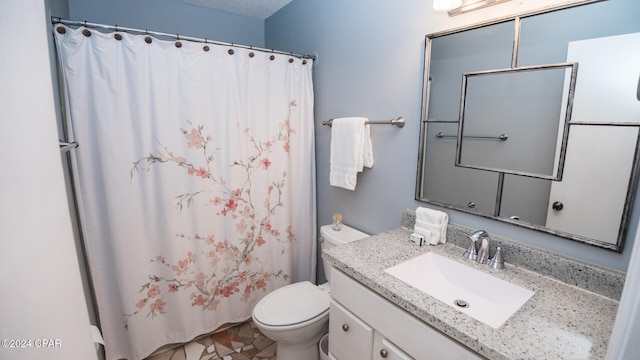 bathroom featuring toilet, vanity, and a shower with shower curtain