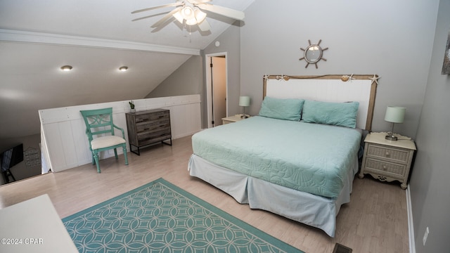 bedroom with ceiling fan, hardwood / wood-style flooring, and vaulted ceiling with beams