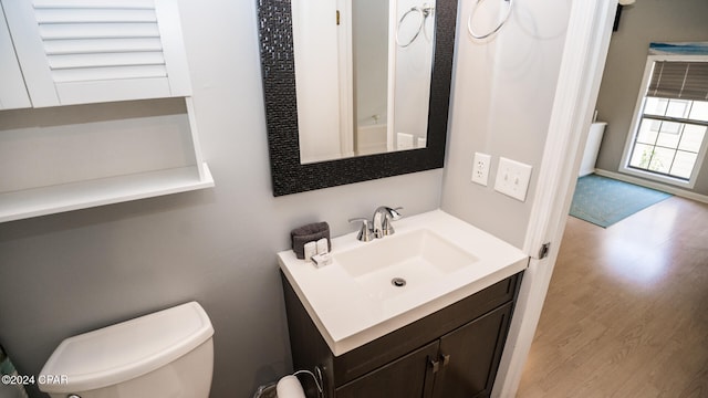 bathroom with vanity, hardwood / wood-style floors, and toilet