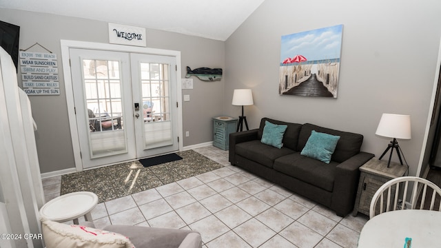 tiled living room featuring french doors and vaulted ceiling