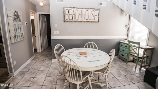 dining area with light tile patterned floors