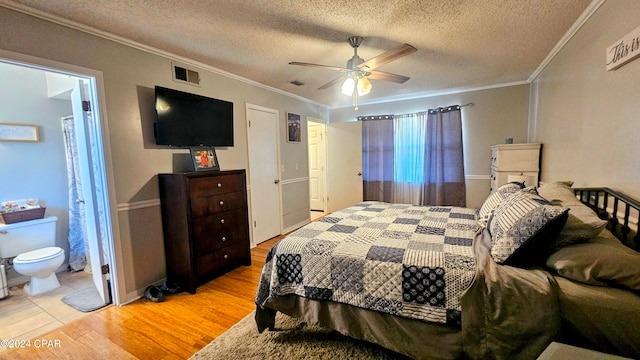 bedroom with light hardwood / wood-style floors, crown molding, ensuite bath, and ceiling fan