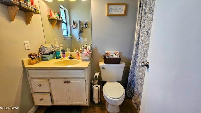 bathroom featuring vanity, toilet, and tile patterned floors