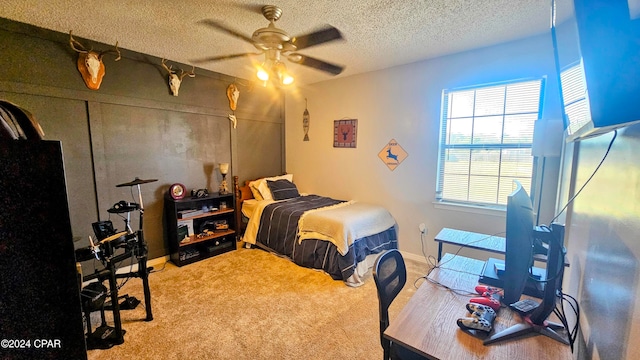 carpeted bedroom with ceiling fan and a textured ceiling